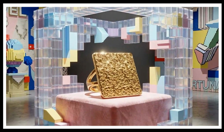 Textured gold square ring on a pink plinth in a clear cube display