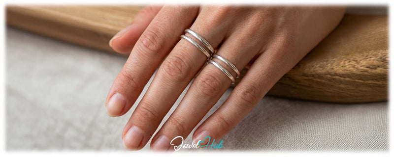 Two silver rings layered on one hand for a balanced, easy look