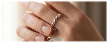 Spinning a silver ring on the finger, a calming fidget ring from JewelHub