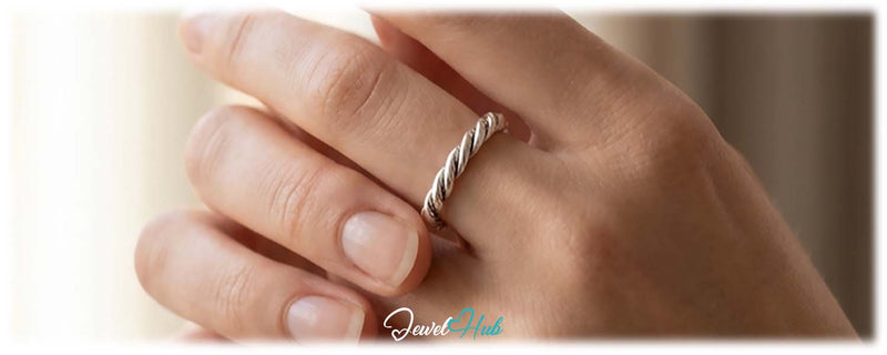 Spinning a silver ring on the finger, a calming fidget ring from JewelHub
