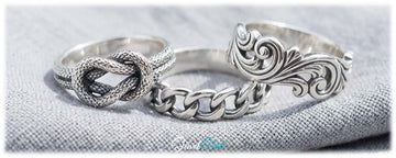 925 silver rings in textured knot, chain link and floral swirl styles