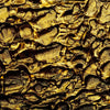 a close up of a textured surface with gold paint