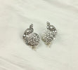a pair of silver colored earrings on a white background