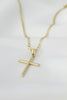 A gold necklace with a cross on it