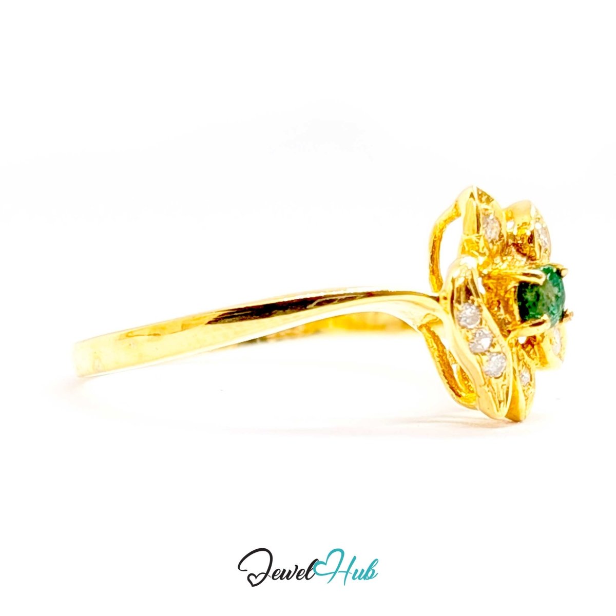 A yellow 14k gold ring featuring a floral cluster setting with a central green emerald and small clear accent stones, shown on a white background with a 'JewelHub' watermark at the bottom.