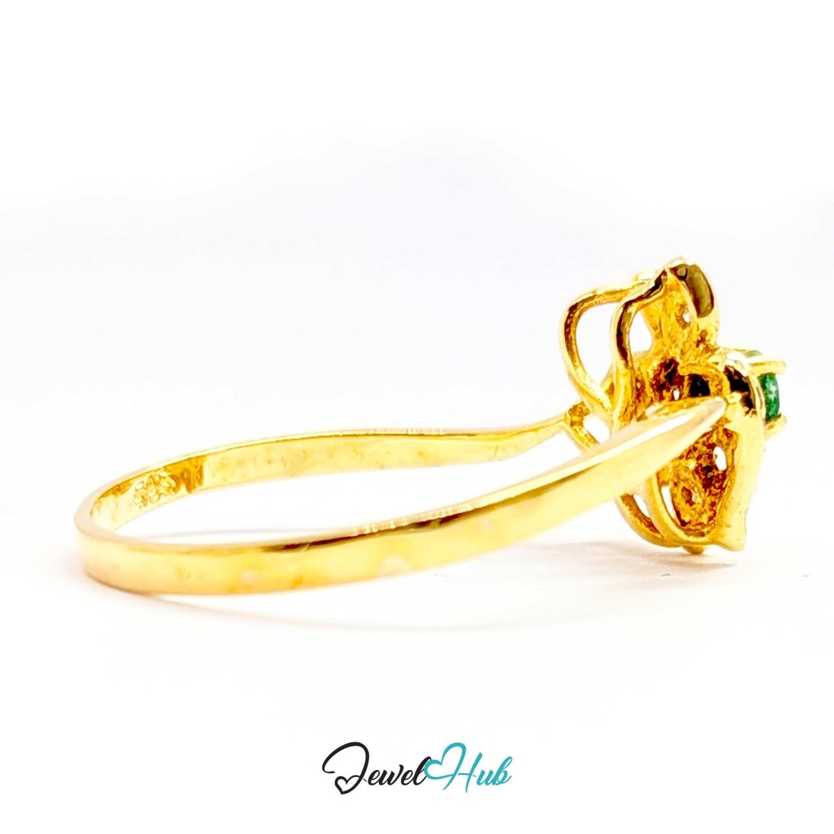 A yellow 14k gold ring with a floral cluster setting featuring a small green gemstone, shown on a white background with a 'JewelHub' watermark at the bottom.
