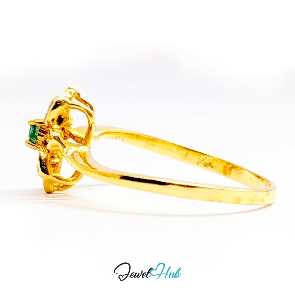 A yellow 14k gold ring with a decorative floral or butterfly-like setting and a small green gemstone, shown on a white background with a 'JewelHub' watermark.