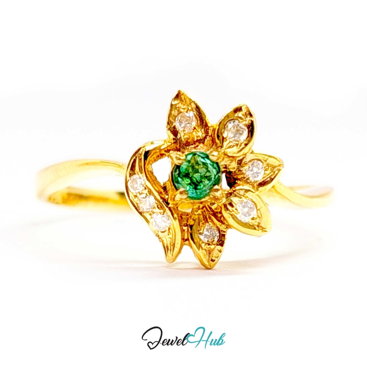A yellow 14k gold ring shaped like a flower, featuring a central round green emerald-cut stone surrounded by six leaf-shaped settings with small clear stones. The ring is shown on a white background with a 'JewelHub' watermark at the bottom.