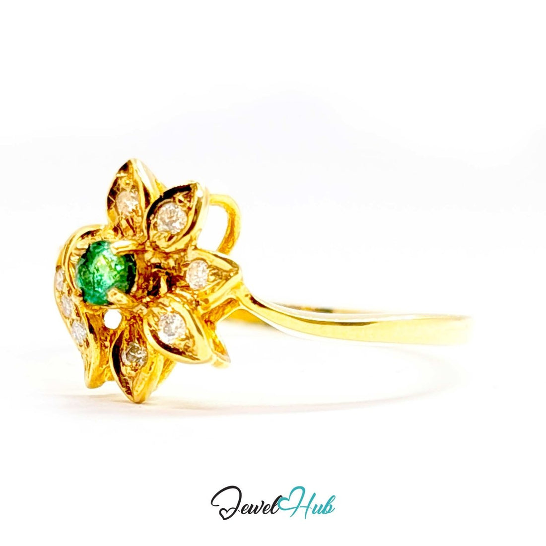 A yellow 14k gold flower-shaped ring featuring a central round green emerald-cut gemstone and multiple small round-cut diamonds set in petal-like shapes, shown on a white background with a JewelHub watermark.