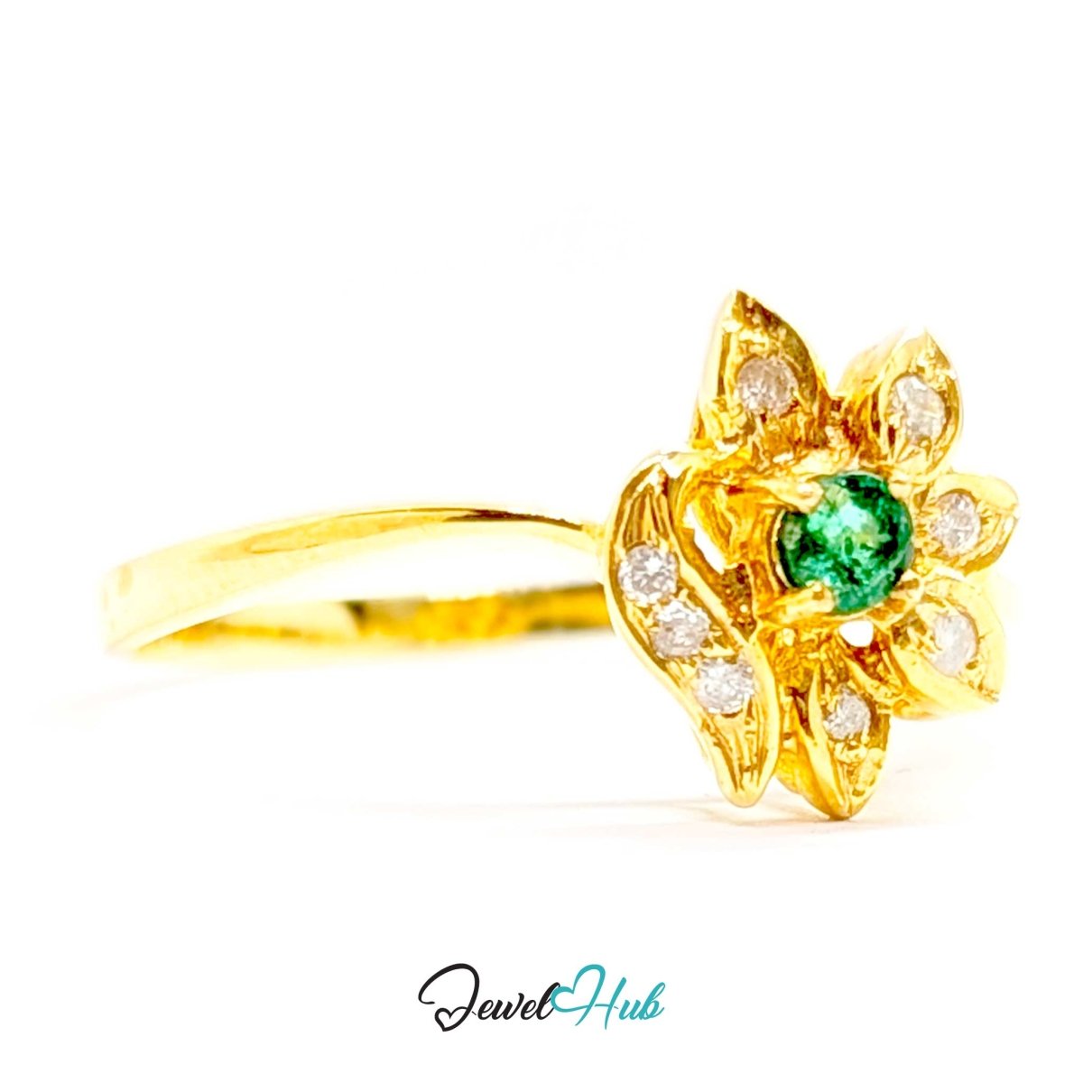 A yellow 14k gold ring featuring a lotus-shaped floral setting with a round green emerald center stone and small clear accent stones, shown on a white background with a JewelHub watermark.