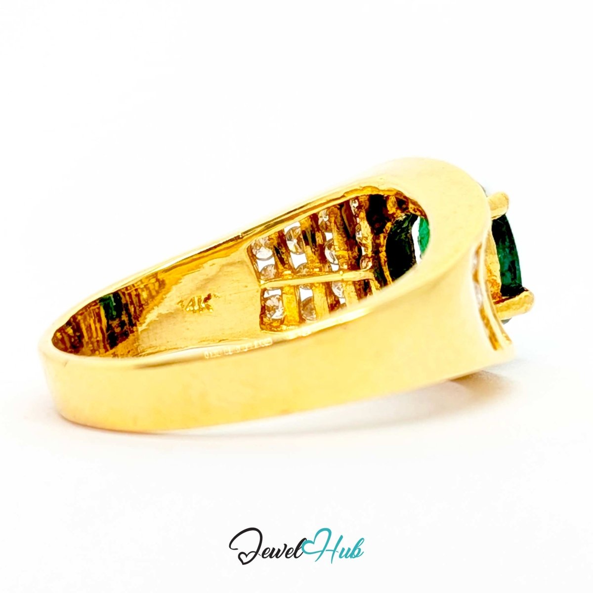 A yellow 14k gold ring shown from a side angle on a white background, featuring a curved band with a central channel of small clear stones and a prominent green rectangular gemstone on the right.