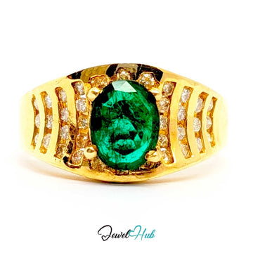 A 14k yellow gold ring featuring a large oval-cut green emerald gemstone in the center, surrounded by small clear accent stones set in a split shank design, shown on a white background with a 'JewelHub' watermark.