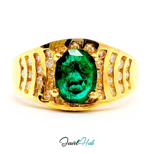 A 14k yellow gold ring featuring a large oval-cut green emerald gemstone in the center, surrounded by small clear accent stones set in a split shank design, shown on a white background with a 'JewelHub' watermark.