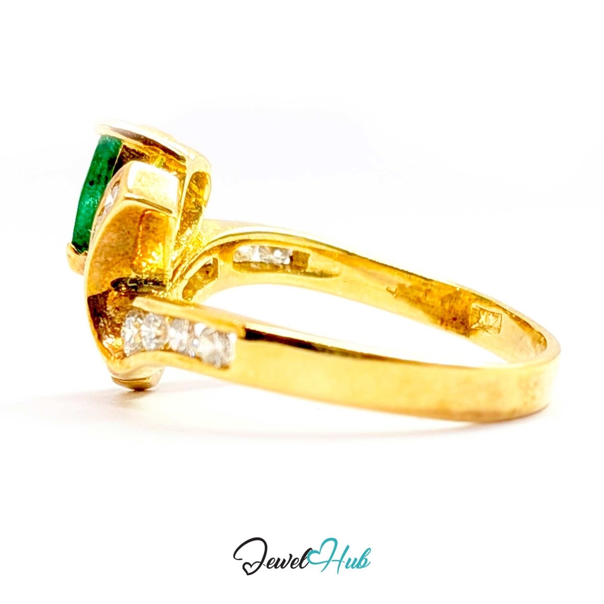 A yellow 14k gold ring featuring a rectangular green emerald-cut gemstone and small clear accent stones along the band, shown on a white background with a JewelHub watermark.