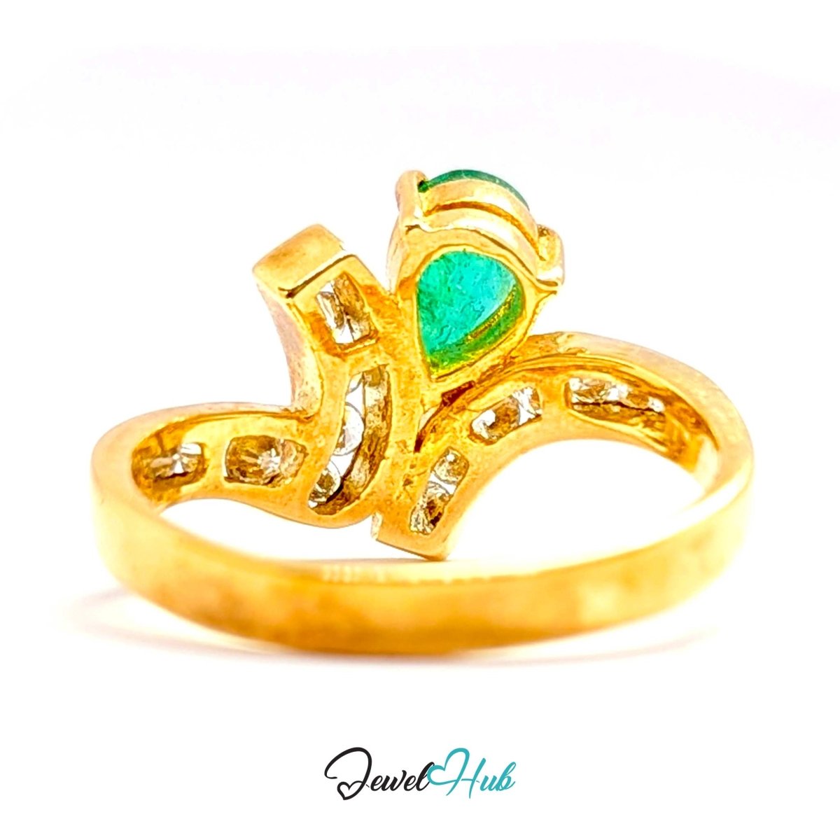 A 14k gold ring featuring a heart-shaped green emerald gemstone and small clear accent stones, shown on a white background with a JewelryHub watermark.