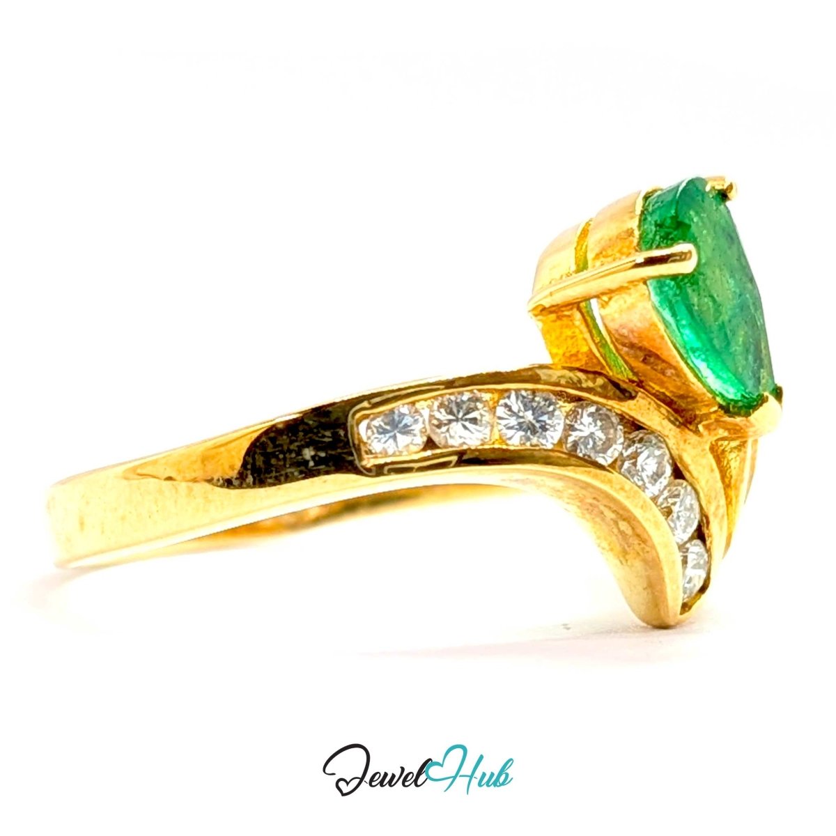 A 14k yellow gold ring featuring a large green emerald-cut center stone and a row of small clear stones along the band, shown on a white background with a JewelHub watermark.