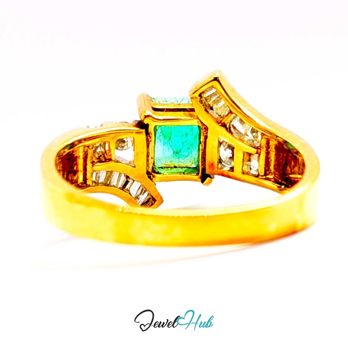A 14k yellow gold ring featuring a central rectangular emerald-cut green gemstone, flanked by curved sections set with small clear stones, shown on a white background with a JewelHub watermark.