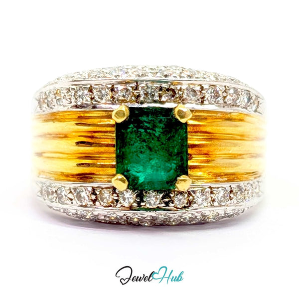 A wide 14k gold and silver band ring featuring a central green emerald-cut gemstone, surrounded by small clear stones along the top and bottom, with textured gold bars on either side of the center stone. The ring is photographed on a white background with a 'JewelHub' watermark at the bottom.