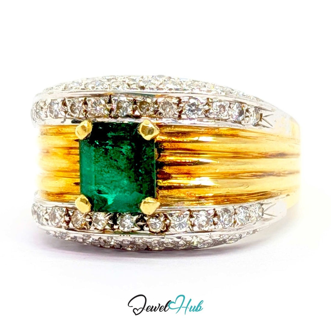 A wide 14k gold and silver band ring featuring a central green emerald-cut gemstone, surrounded by small clear stones along the top and bottom, with textured gold bars on either side of the center stone. The ring is photographed on a white background with a 'JewelHub' watermark at the bottom.