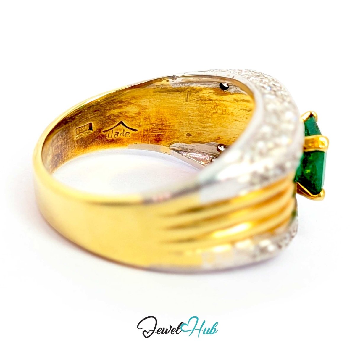 A 14k yellow gold ring with a textured band, a curved silver-colored pavé setting, and a green baguette-cut gemstone on the right side, shown on a white background with a 'JewelHub' watermark.