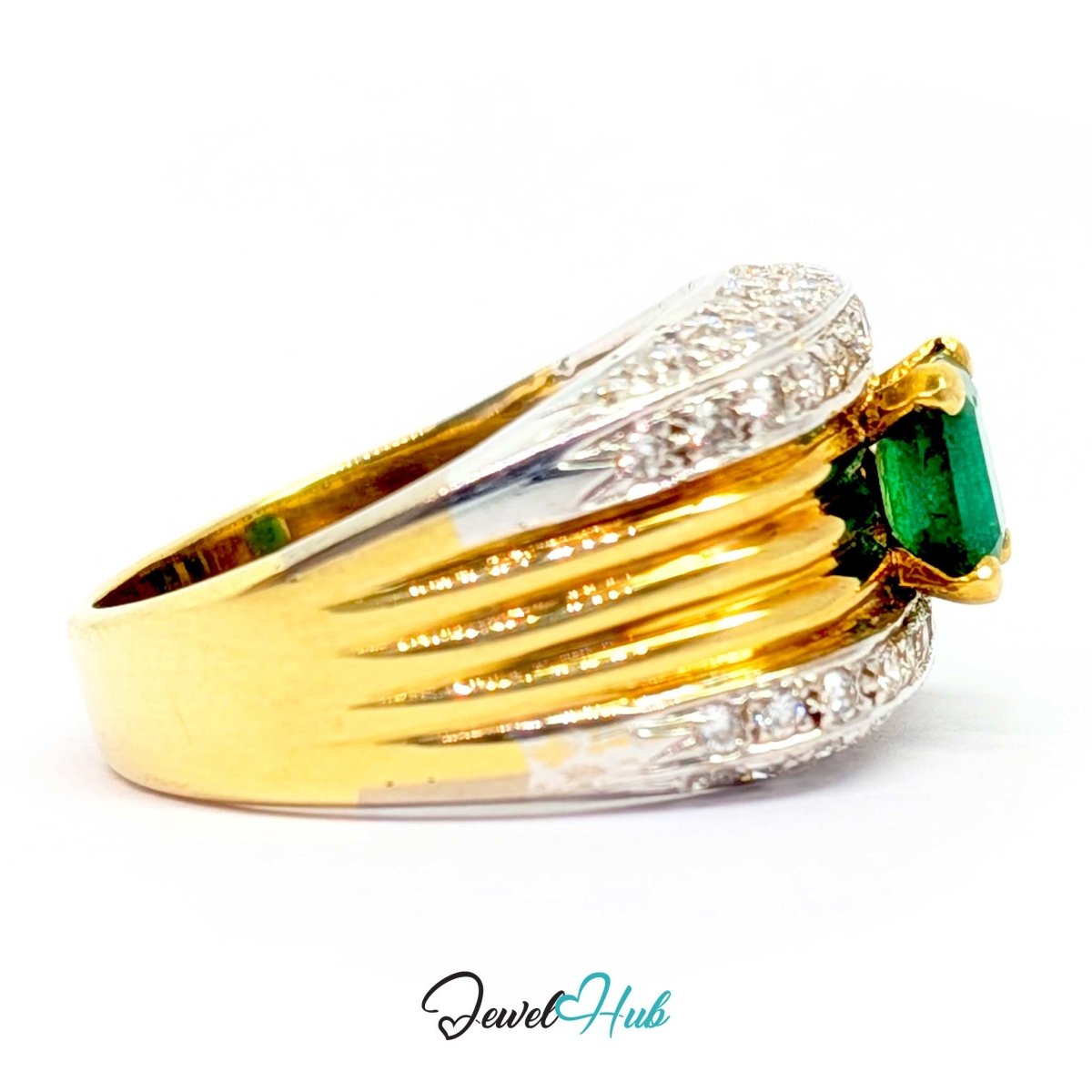 A two-tone 14k yellow gold and white gold ring featuring a rectangular green emerald-cut center stone and rows of small clear stones along the band, shown on a white background with a 'JewelHub' watermark.