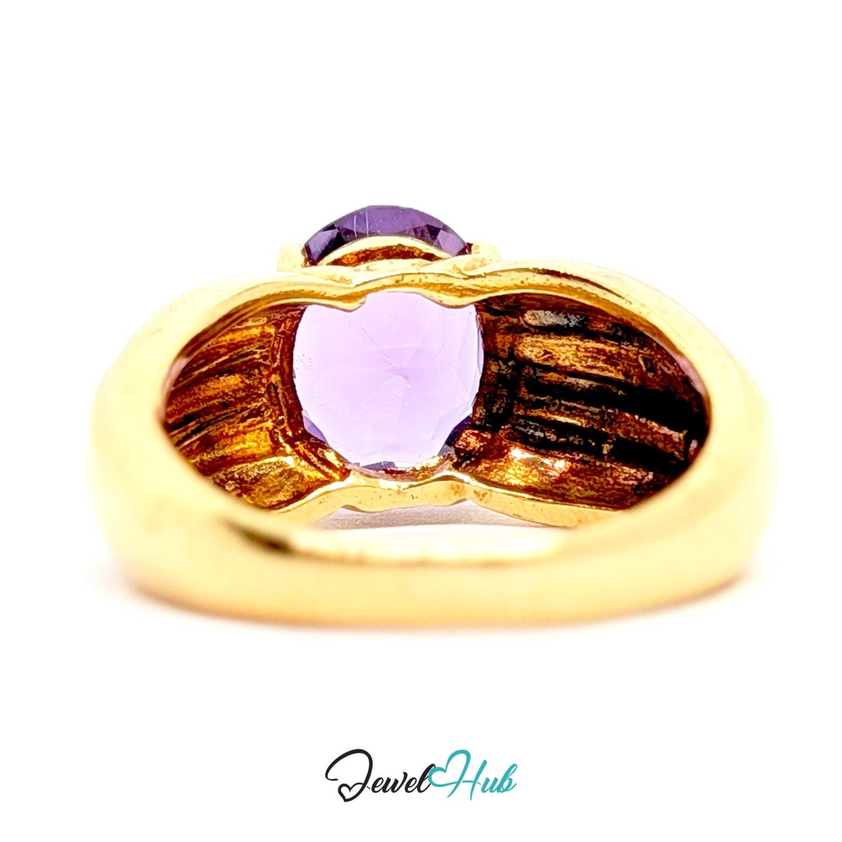 A 14k gold ring with a heart-shaped light purple gemstone in the center and a smaller dark purple gemstone above it, shown on a white background with a JewelHub watermark.