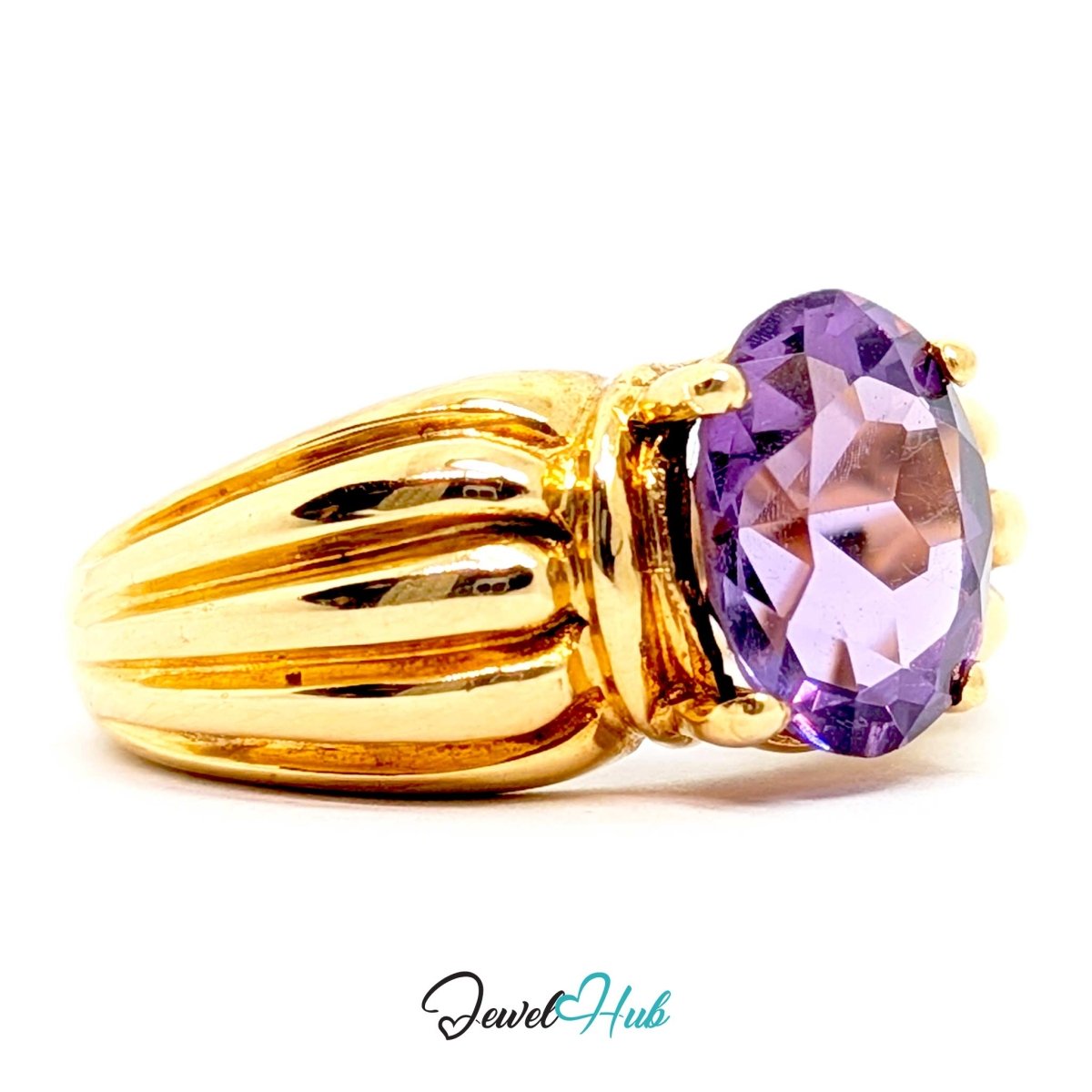 A 14k gold ring featuring a large oval-cut purple amethyst gemstone, shown on a clean white background with a 'JewelHub' watermark at the bottom.
