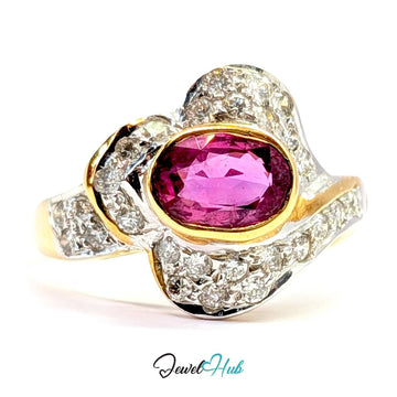 A solid 14k gold and white gold ring featuring a large oval-cut pink gemstone in the center, surrounded by pavé-set clear stones and accented with yellow gold details, shown on a white background with a 'JewelHub' watermark.