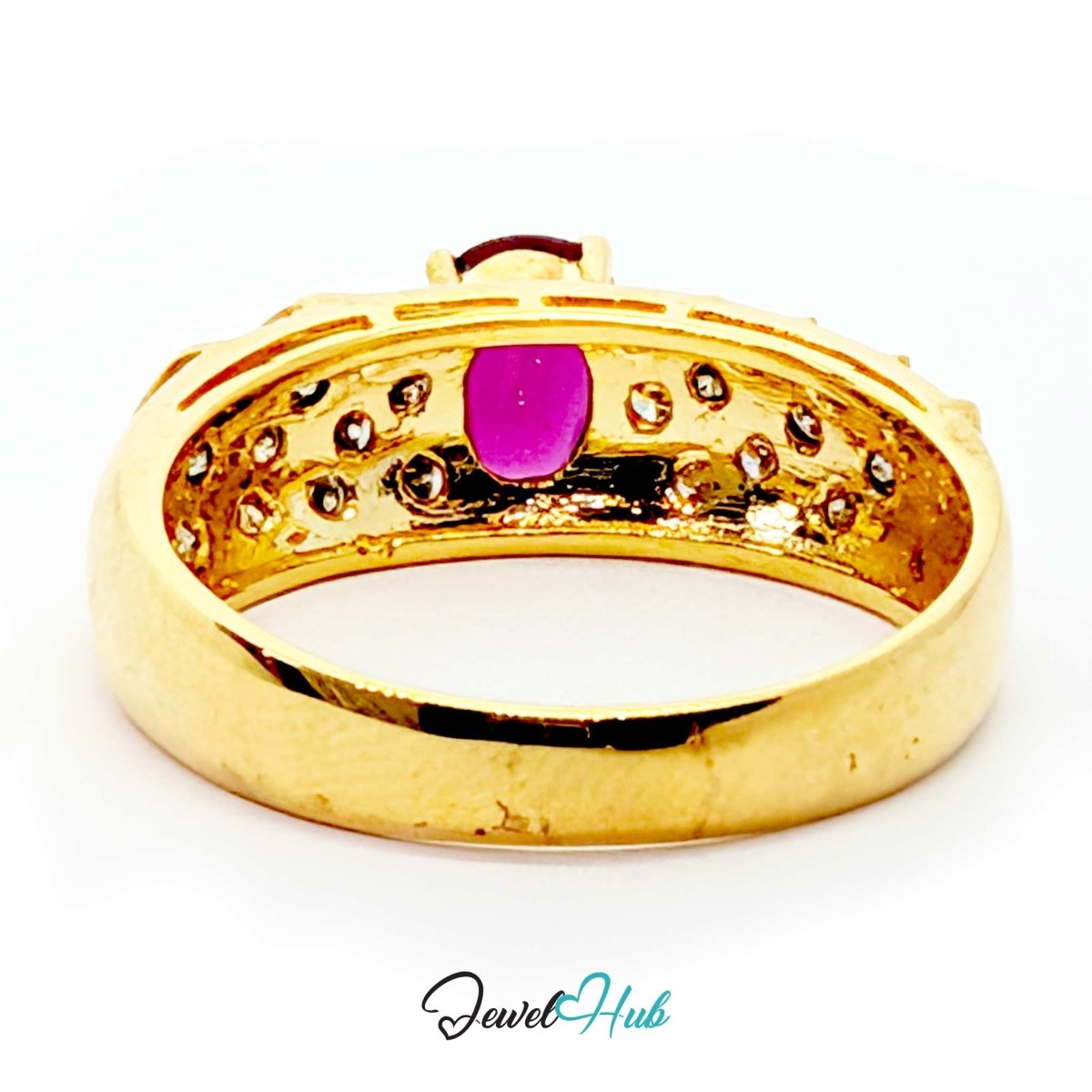 A 14k solid gold ring with a central oval magenta-pink gemstone and small clear stones set around the band, shown on a white background with a 'JewelHub' watermark at the bottom.
