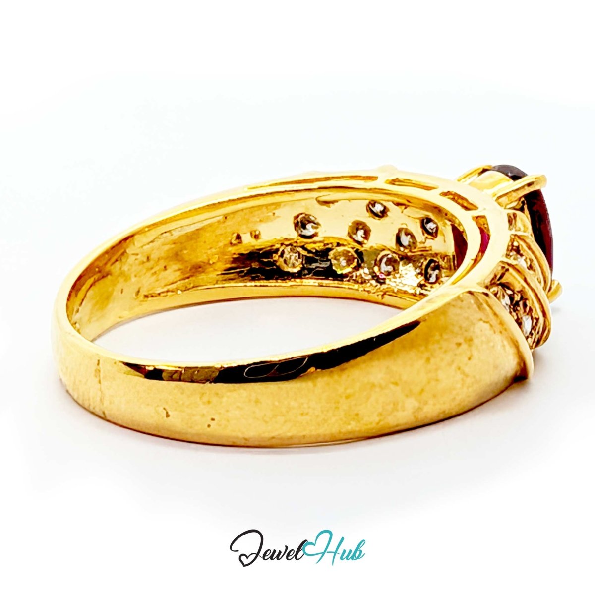 A yellow 14k gold ring with a textured band and a dark red oval gemstone, shown on a white background with a 'JewelHub' watermark at the bottom.