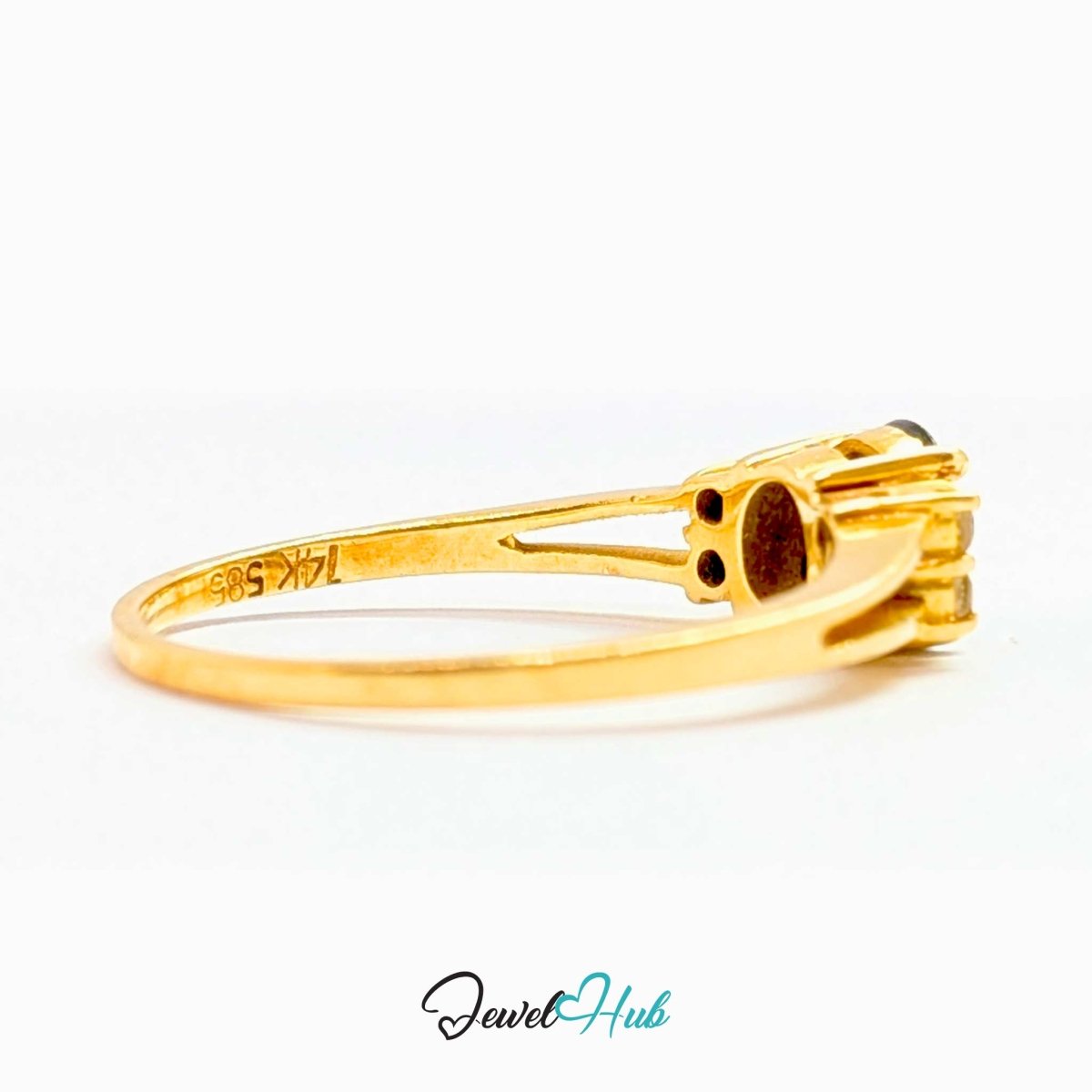 A 14k yellow gold ring shown in profile on a white background, with the inner band stamped 14K 585. The ring features a multi-stone setting with dark gemstones.