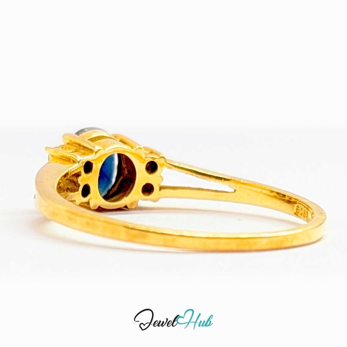 A 14k gold ring with a decorative setting featuring a dark blue and black striped oval stone, shown on a white background with a 'JewelHub' watermark at the bottom.