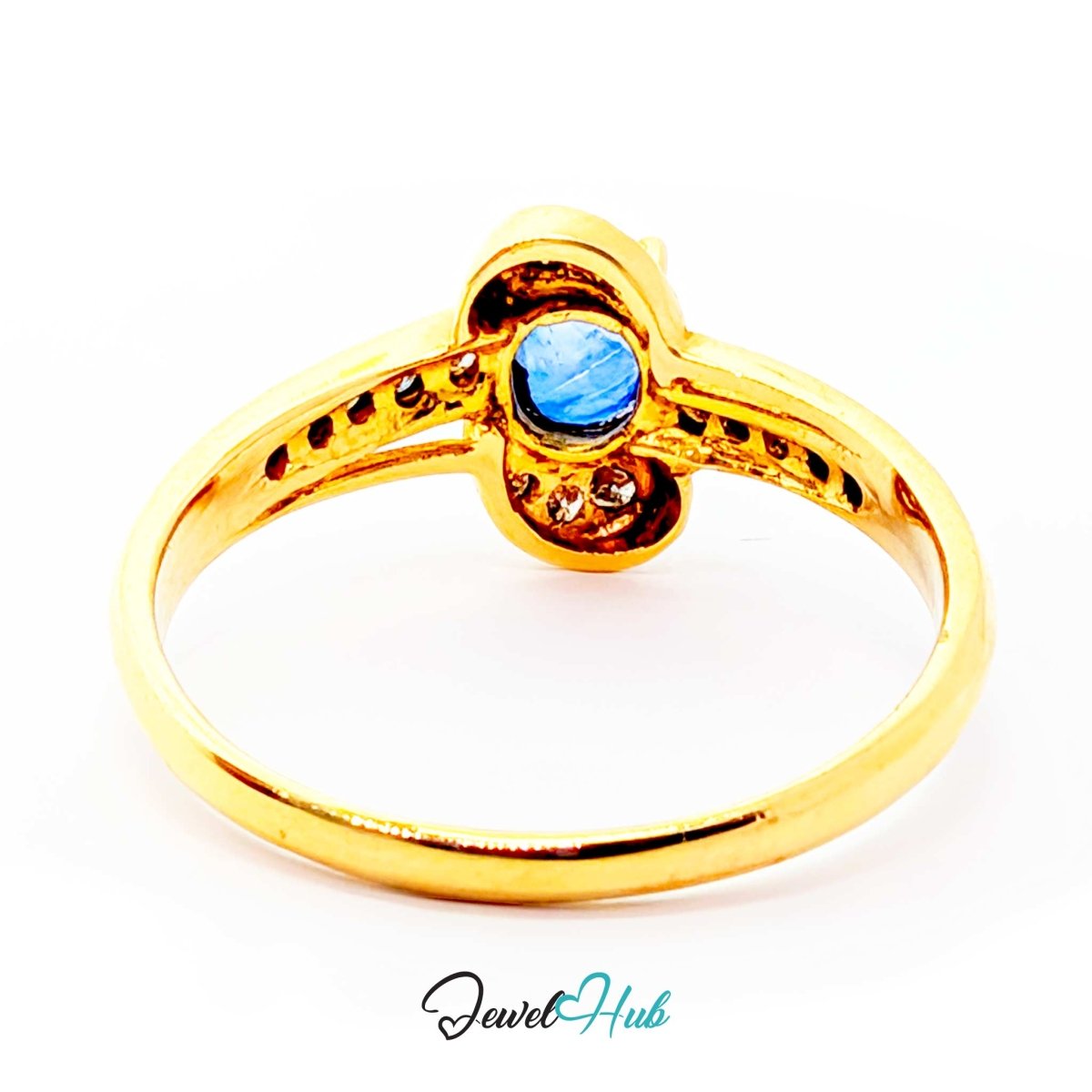 A 14k gold ring with a central round blue gemstone and small accent stones, shown on a plain white background with a JewelHub watermark at the bottom.