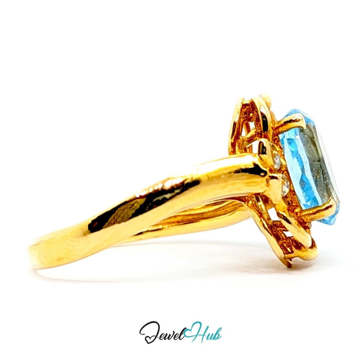 A 14k gold ring with a rectangular light blue gemstone, shown from a side profile on a white background with a 'JewelHub' watermark at the bottom.