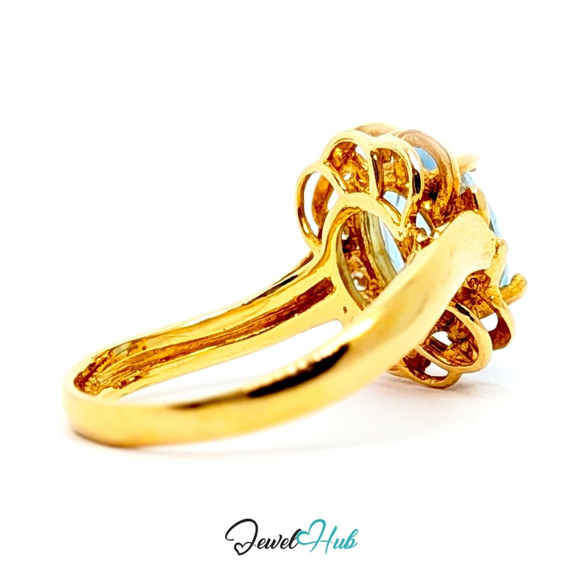 A 14k yellow gold ring with a decorative filigree setting and light blue gemstones, shown on a white background with a 'JewelHub' watermark at the bottom.