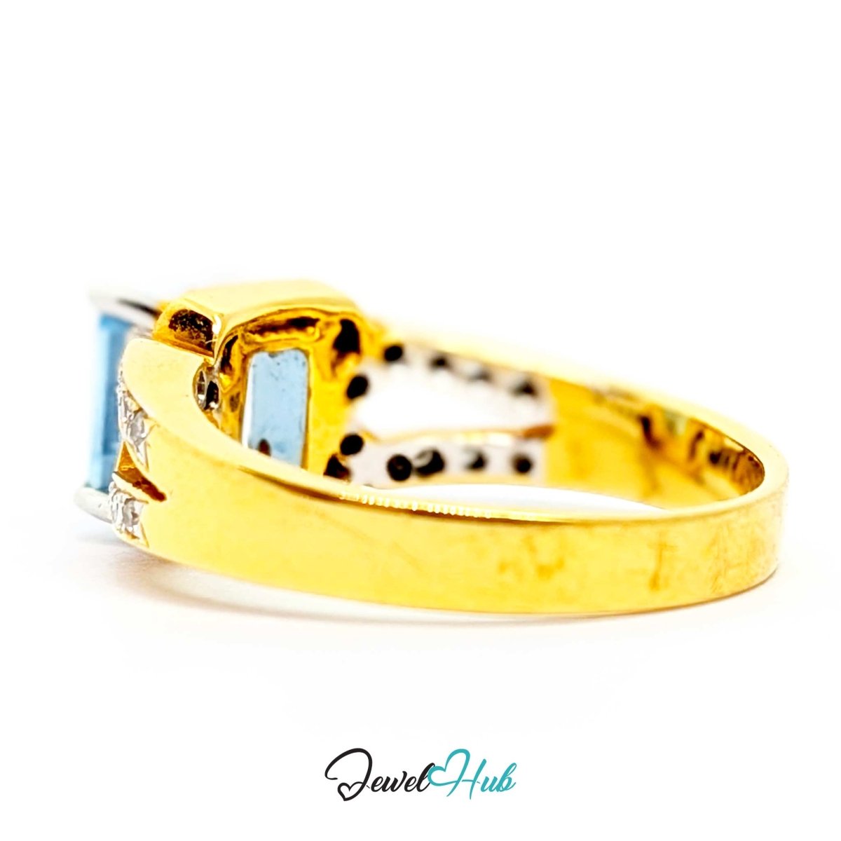 A 18k gold ring with a rectangular light blue gemstone and small clear accent stones, shown on a white background with a JewelHub watermark.