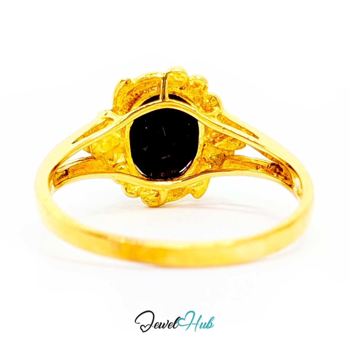 A 18k yellow gold ring featuring a large, oval-shaped black gemstone in an ornate, textured setting with small accent stones, shown on a white background with a 'JewelHub' watermark at the bottom.