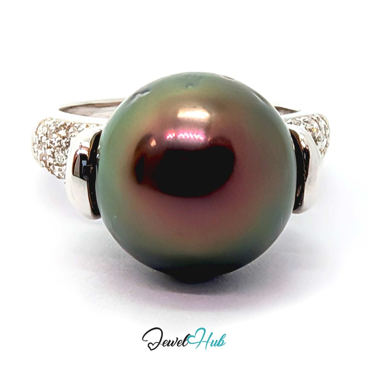 A 18k white gold ring featuring a large, round, iridescent dark green pearl with pinkish undertones, accented by pavé-set clear stones on the band, shown on a white background with a 'JewelHub' watermark.