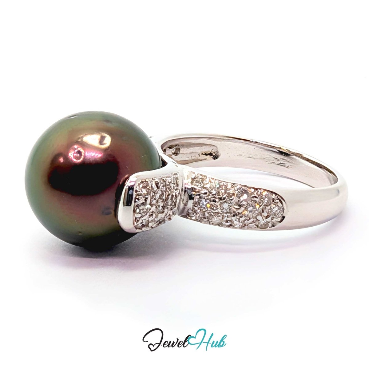 18k white gold ring featuring a large, round, dark green-black Tahitian pearl and a pavé diamond accent on the shank, set against a plain white background.