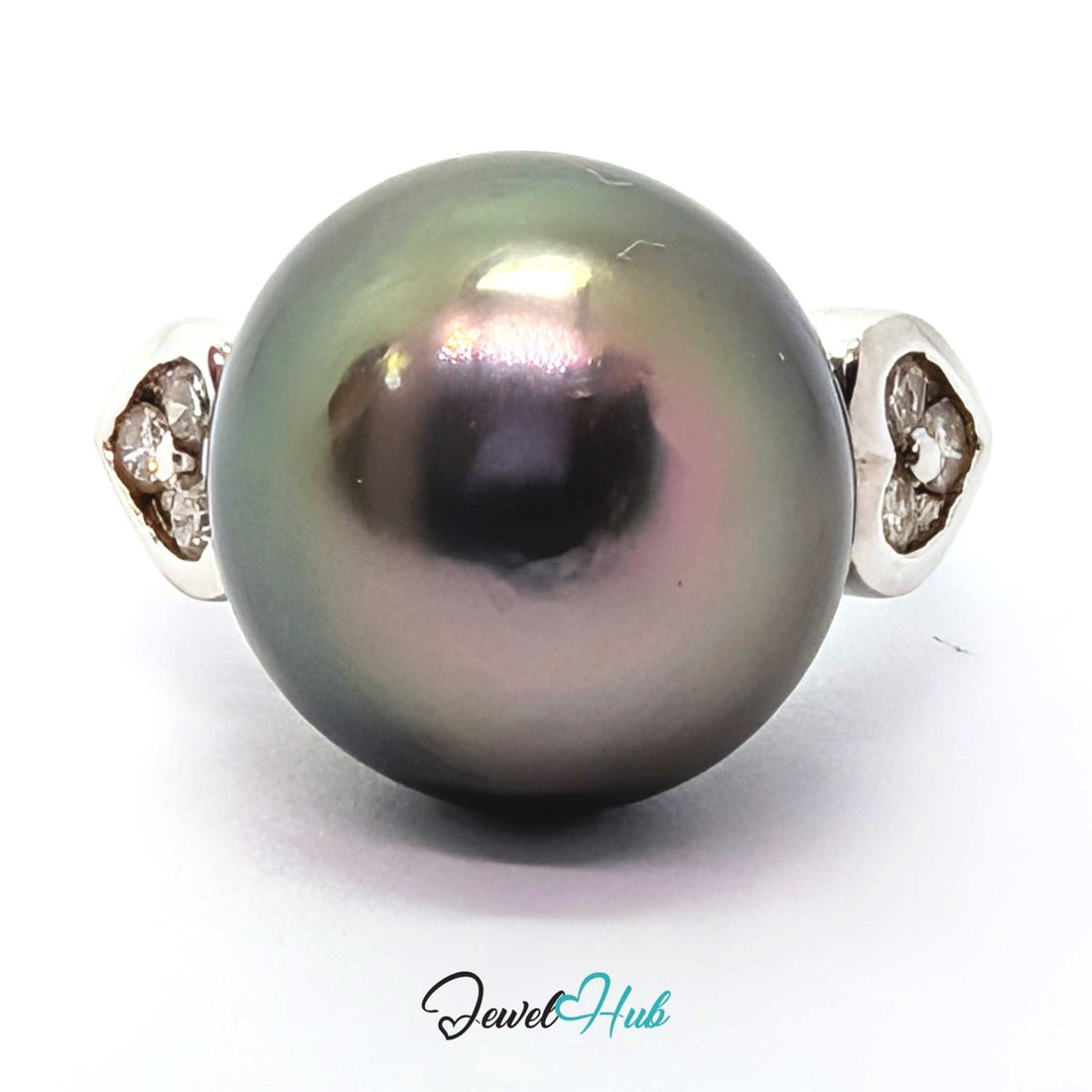 A round dark gray pearl ring with a 18k white gold  setting featuring small clear stones on each side, shown on a white background with a JewelryHub watermark.