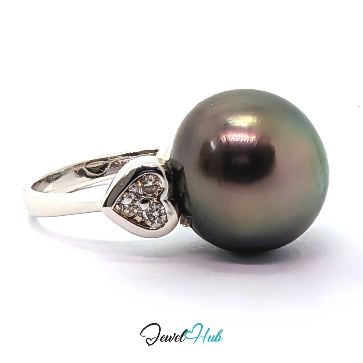 18k white gold  featuring a large, dark, iridescent freshwater pearl and a heart-shaped setting with small clear stones, shown on a white background with a 'JewelHub' watermark.