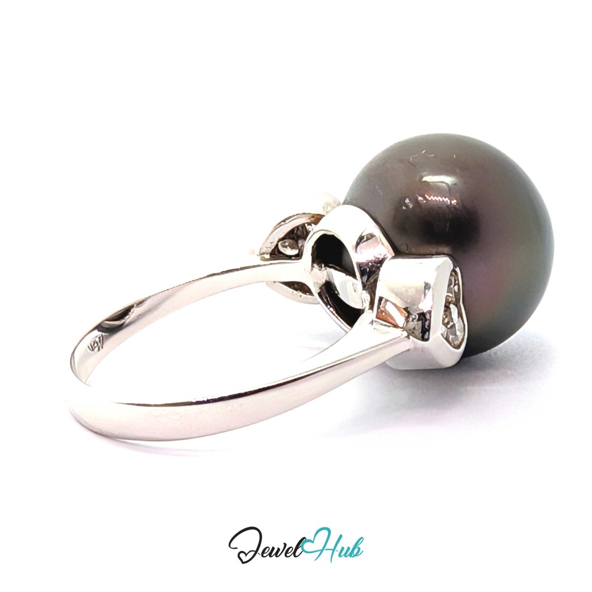 A 18k white gold ring featuring a large, round, dark gray-black pearl set in a polished silver bezel with small accent stones, shown on a white background with a 'JewelHub' watermark.