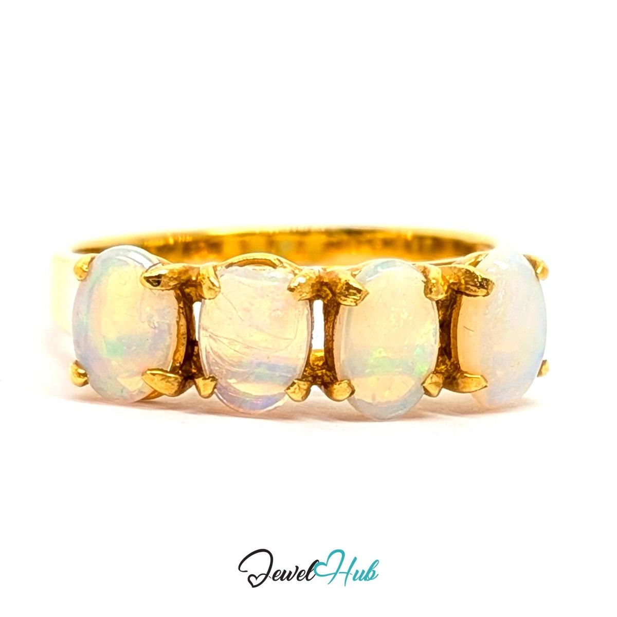 A yellow 18k gold ring featuring four oval-cut white opal gemstones in a four-stone setting, shown on a plain white background with a 'JewelHub' watermark at the bottom.