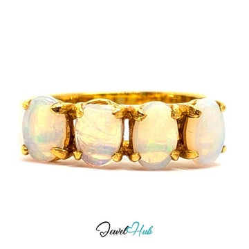 A 18k yellow gold ring featuring five oval-cut white opal gemstones set in a row, shown against a plain white background with a 'JewelHub' watermark at the bottom.