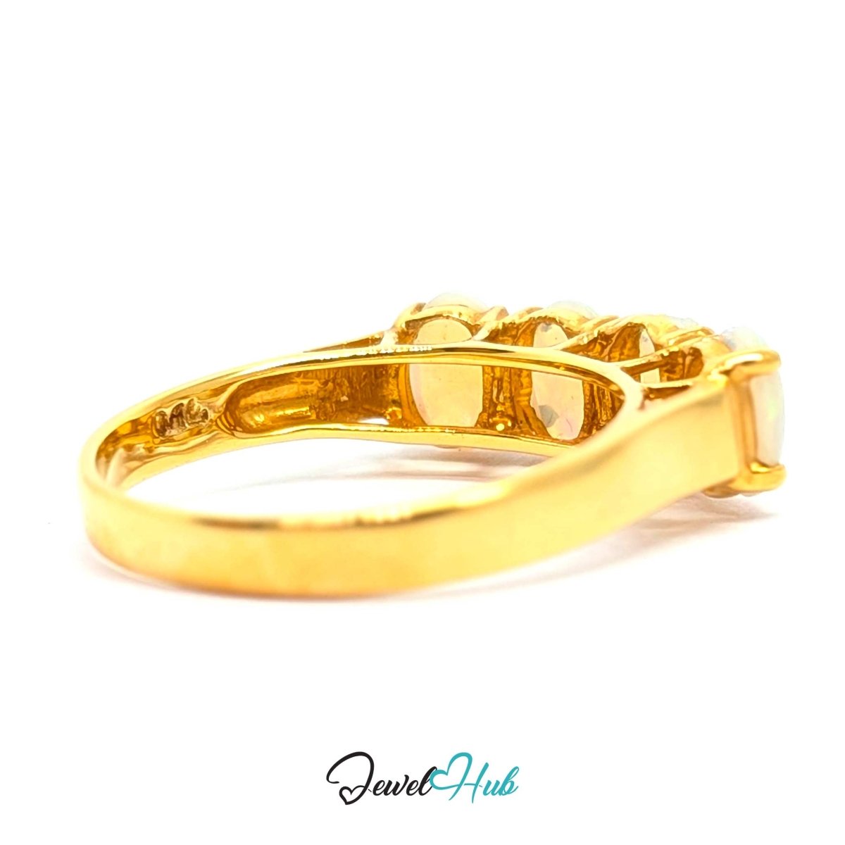 A yellow 18k gold ring with a multi-stone cluster setting and a round clear center stone, shown on a white background with a 'JewelHub' watermark at the bottom.