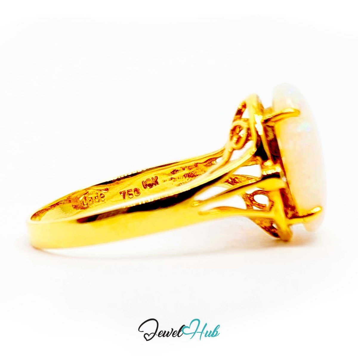 A 18k yellow gold ring with a large oval white opal gemstone, shown from a side angle on a white background. The inner band is stamped with '10K 750 FW'.