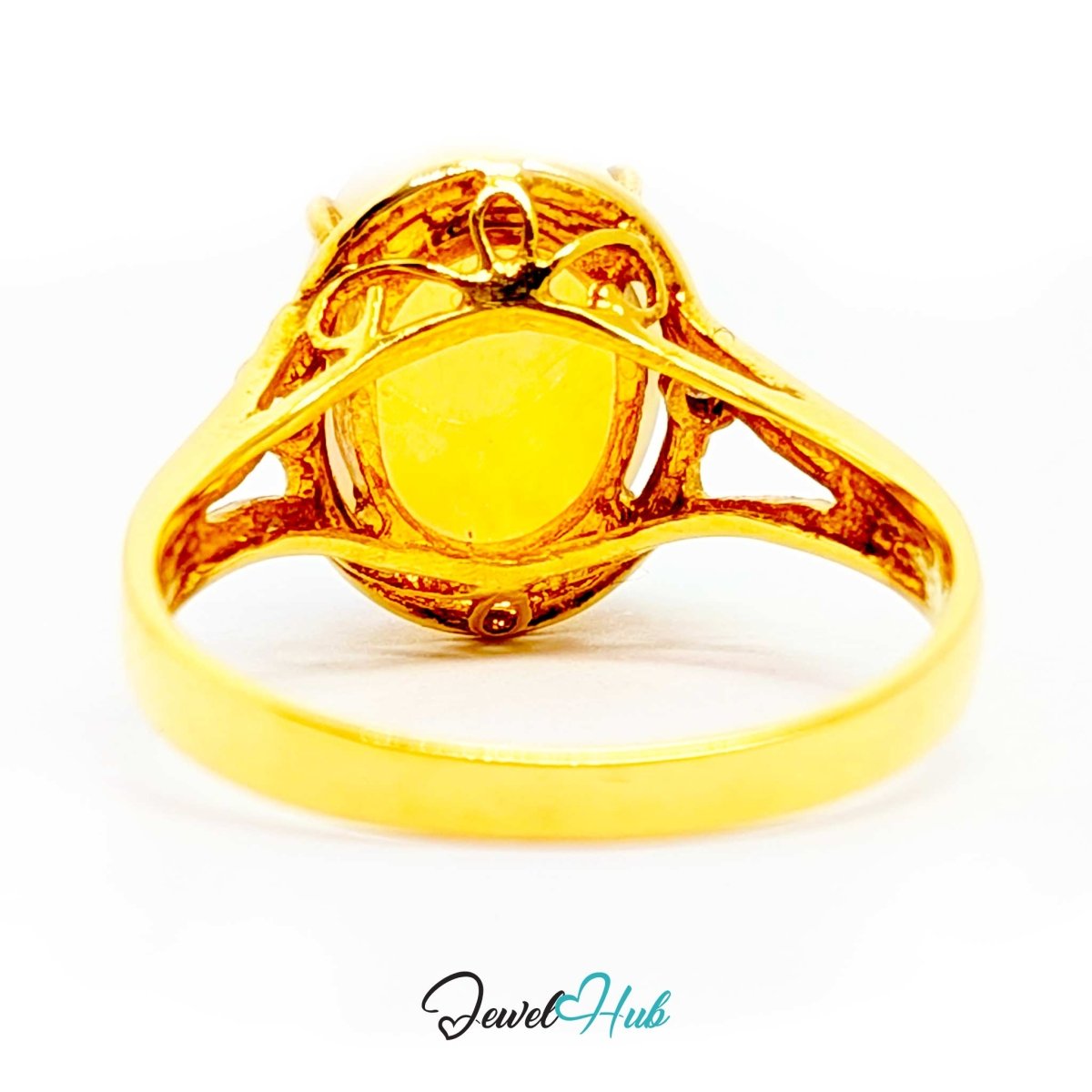 A 18k yellow gold ring with a round bezel-set yellow stone, shown from the back on a white background with a 'JewelHub' watermark at the bottom.