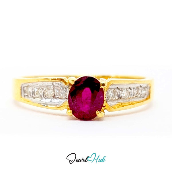 A yellow 14k gold ring featuring a prominent oval-cut deep pinkish-red center stone, flanked by rows of small clear stones on a white background.