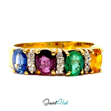 A 18k yellow gold ring featuring five oval-cut gemstones in blue, pink, green, and orange, separated by small diamond accents, shown on a white background with a JewelryHub watermark.