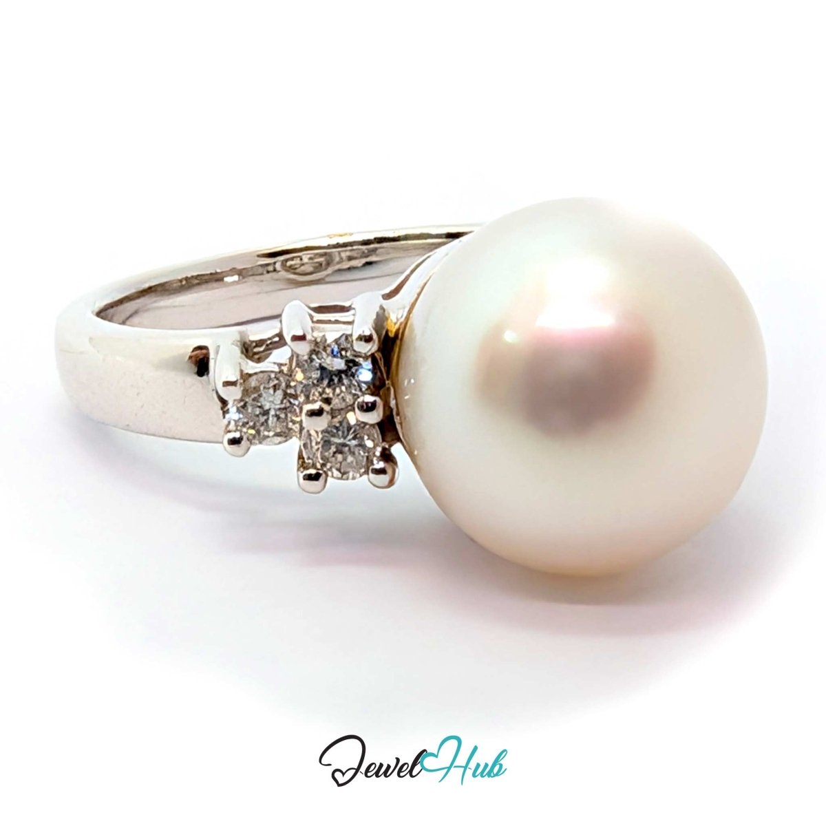 A white freshwater pearl ring set in a white gold band with three small clear accent diamonds, shown on a white background with a JewelryHub watermark.